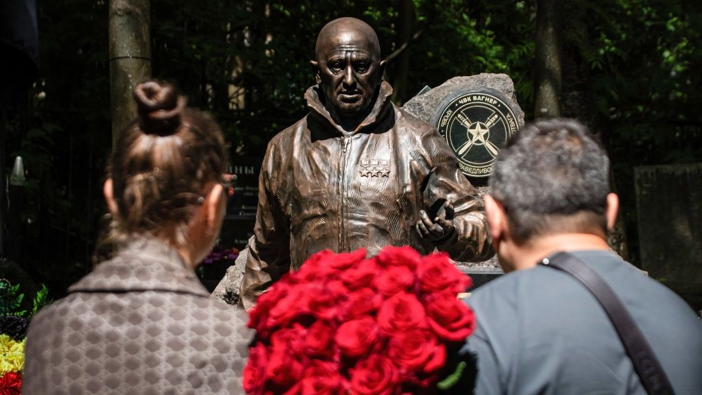 People stand with a bouquet of roses near a sculpture of
ST  PETERSBURG, RUSSIA - 2024/06/01: People stand with a bouquet of roses near a sculpture of Russian mercenary leader Yevgeny Prigozhin installed on his grave during celebrations of his birthday to honor his memory at Porokhovskoye Cemetery in St. Petersburg. A monument to Wagner PMC founder Yevgeny Prigozhin was unveiled at the Pokhorovskoye cemetery in St. Petersburg on what would have been his 63rd birthday, June 1. PMC members and civilians laid flowers at the monument. Prigozhin died on August 23, 2023, in a crash involving his Embraer business jet in the Tver region of Russia. (Photo by Artem Priakhin/SOPA Images/LightRocket via Getty Images)
SOPA Images
st. petersburg, installed, wagner pmc, mercenary leader, private military company, pmc, mercenary, tribute, roses, wagner, porokhovskoye cemetery, russian, leader