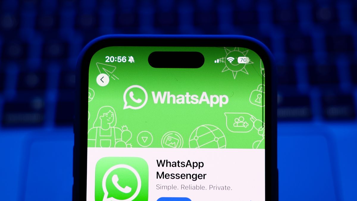 A laptop keyboard and WhatsApp on App Store displayed on a phone screen are seen in this illustration photo taken in Poland on October 8, 2024. (Photo by Jakub Porzycki/NurPhoto via Getty Images)