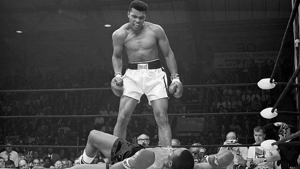 Muhammad Ali Taunting Sonny Liston
Heavyweight champion Muhammad Ali stands over Sonny Liston and taunts him to get up during their title fight. Ali knocked Liston out in one minute in the first round during their bout at the Central Maine Youth Center in Lewiston, Maine.
Bettmann
1960s:CB3, challenge:CB2, African-American ethnicity:CB2, aggression:CB3, photographing:CB2, mid-adult man:CB3, large group of people:CB2, sports:CB3, boxing ring:CB2, Ali vs. Liston:CB3, celebrities:CB2, lying down:CB3, heavyweight boxer:CB3, champion:CB3, Lewiston:CB2, Sonny Liston:CB3, Muhammad Ali:CB3, iconic:CB3, taunting:CB3