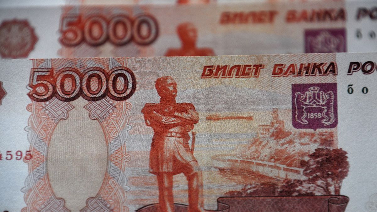 FRANCE - 2022/03/01: In this photo illustration, Russian banknotes of 5000 rubles seen displayed.The Russian ruble plunged almost 30% against the dollar after the invasion of Ukraine. The United States and the European Union had declared that they would exclude certain Russian banks from the international system of Swift banking payments. (Photo Illustration by Gerard Bottino/SOPA Images/LightRocket via Getty Images)
