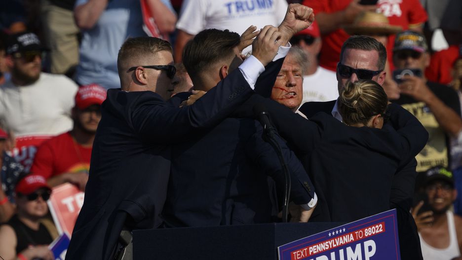 Donald Trump Holds A Campaign Rally In Butler, Pennsylvania
BUTLER, PENNSYLVANIA - JULY 13:  Republican presidential candidate, former U.S. President Donald Trump is whisked away by Secret Service after shots rang out at a campaign rally at Butler Farm Show Inc. on July 13, 2024 in Butler, Pennsylvania. Trump slumped and injuries were visible to the side of his head. Butler County district attorney Richard Goldinger said the shooter and one audience member are dead and another was injured.  (Photo by Jeff Swensen/Getty Images)
Jeff Swensen