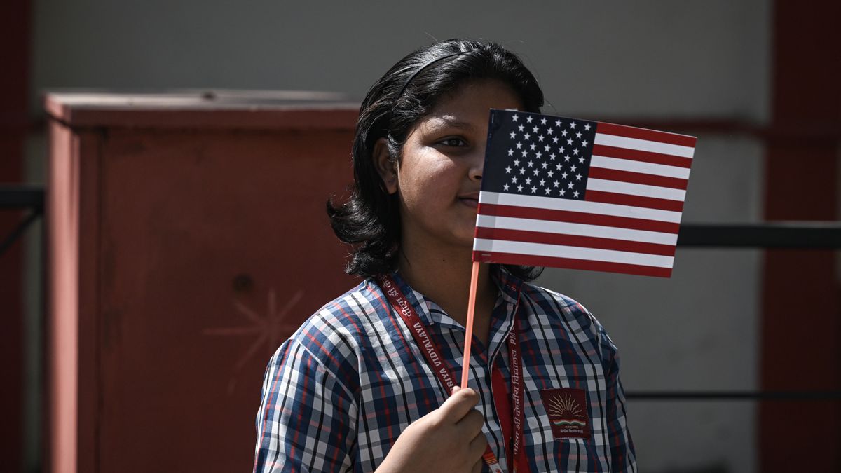 AGRA, INDIA - APRIL 23: A child holds an American flag as residents line the street to see U.S. Vice President JD Vance's motorcade pass by en route to the Taj Mahal on April 23, 2025 in Agra, India. Vance and Indian Prime Minister Narendra Modi yesterday indicated progress had been made in talks for a trade deal between the two countries as New Delhi attempts to boosts ties with the Trump administration and avoid steep U.S. tariffs. (Photo Kenny Holston - Pool/Getty Images)