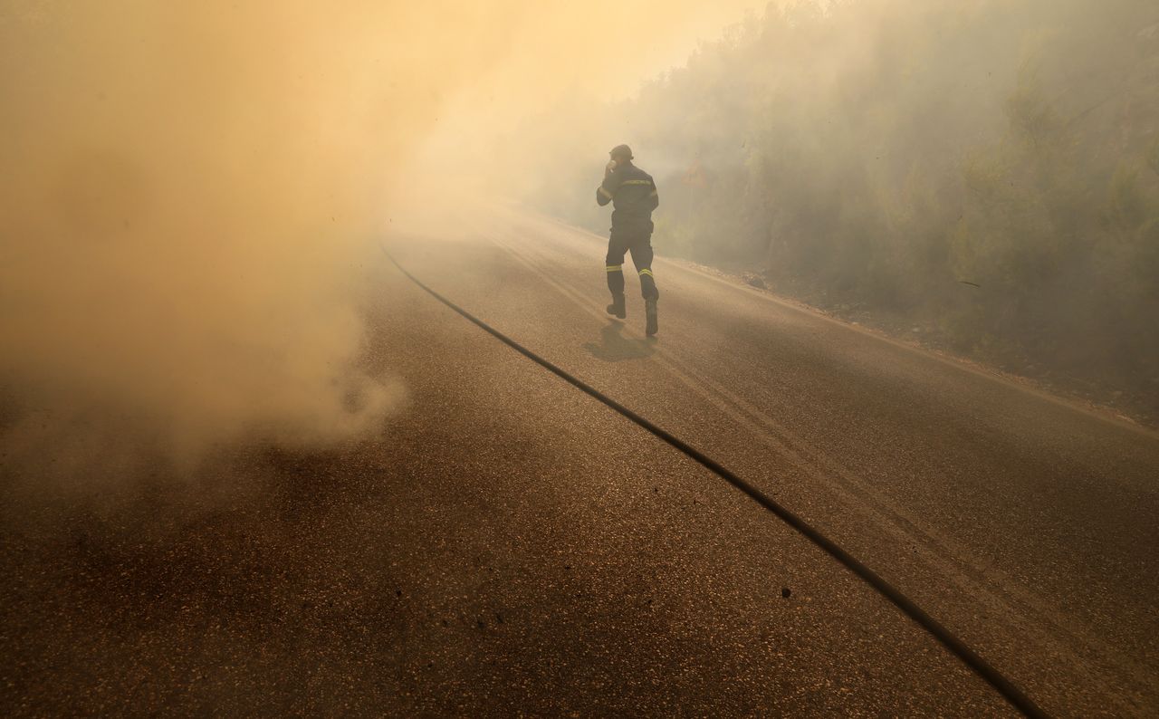 Fire near Athens claims life, forces mass evacuations