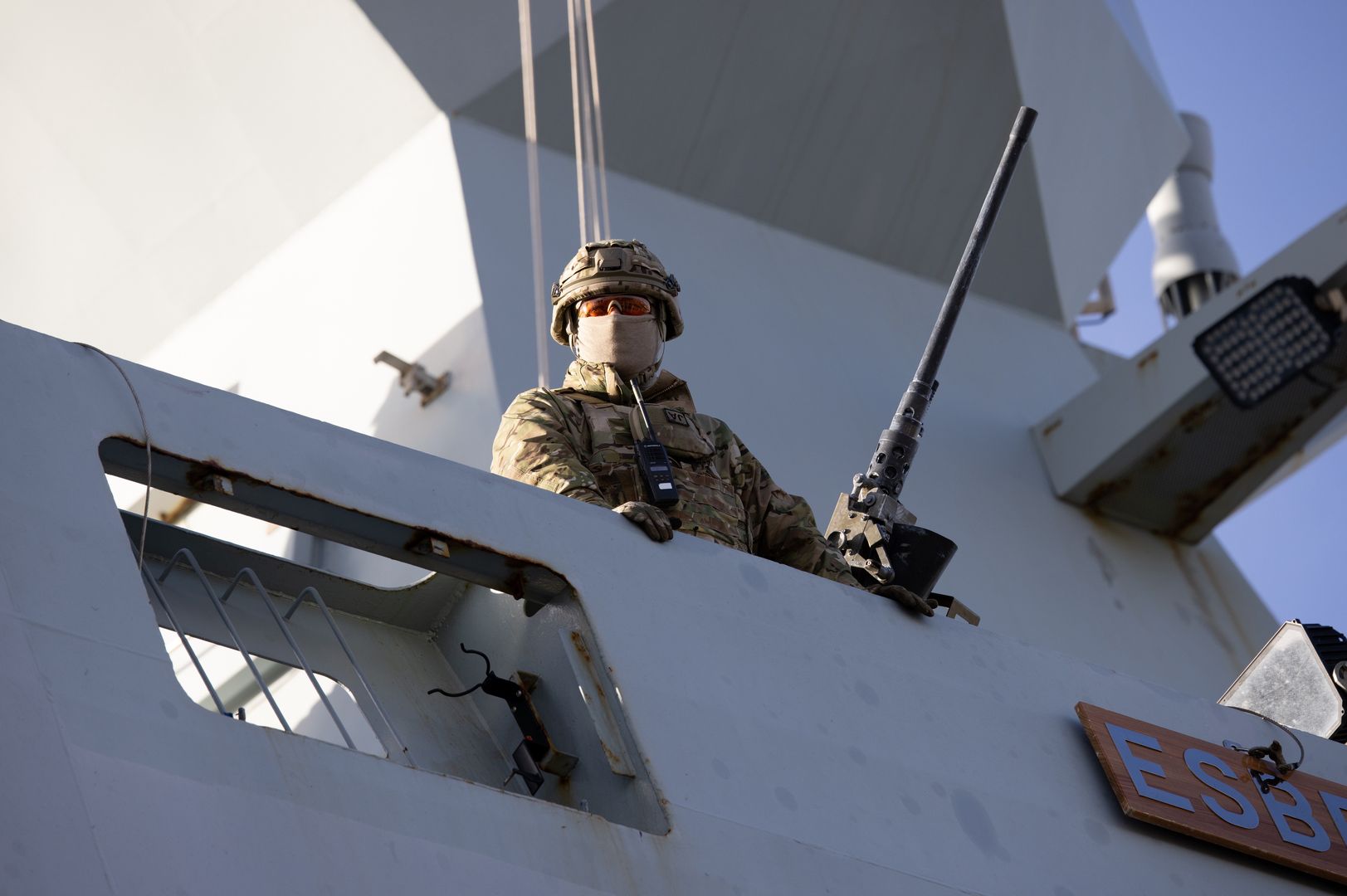 An armed soldier watches from the deck of the Danish Absalon-class frigate Esbern Snare (F342), part of the Standing NATO Maritime Group, moored at the passenger port in Riga, Latvia, on Sunday, Oct. 30, 2022. For the Baltics, Moscow will remain a threat in eastern Europe regardless of the outcome of the war, with no indication that Kremlins foreign policy will change, Mikk Marran, Estonias outgoing espionage chief, said. Photographer: Andrey Rudakov/Bloomberg via Getty Images