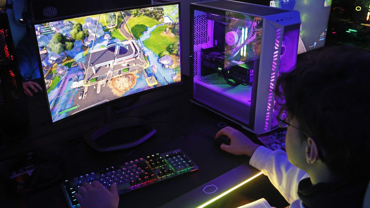 PARIS, FRANCE - NOVEMBER 03: A gamer plays a video game 
with an ARGB Grand Tower Case, Cooler Master COSMOS C700M during Paris Games Week 2022 at Parc des Expositions Porte de Versailles on November 03, 2022 in Paris, France. After two years of absence linked to the Covid-19 pandemic, Paris Games Week is making a comeback in Paris. The event celebrating video games and esports will be held from November 2 to 6, 2022. (Photo by Chesnot/Getty Images)