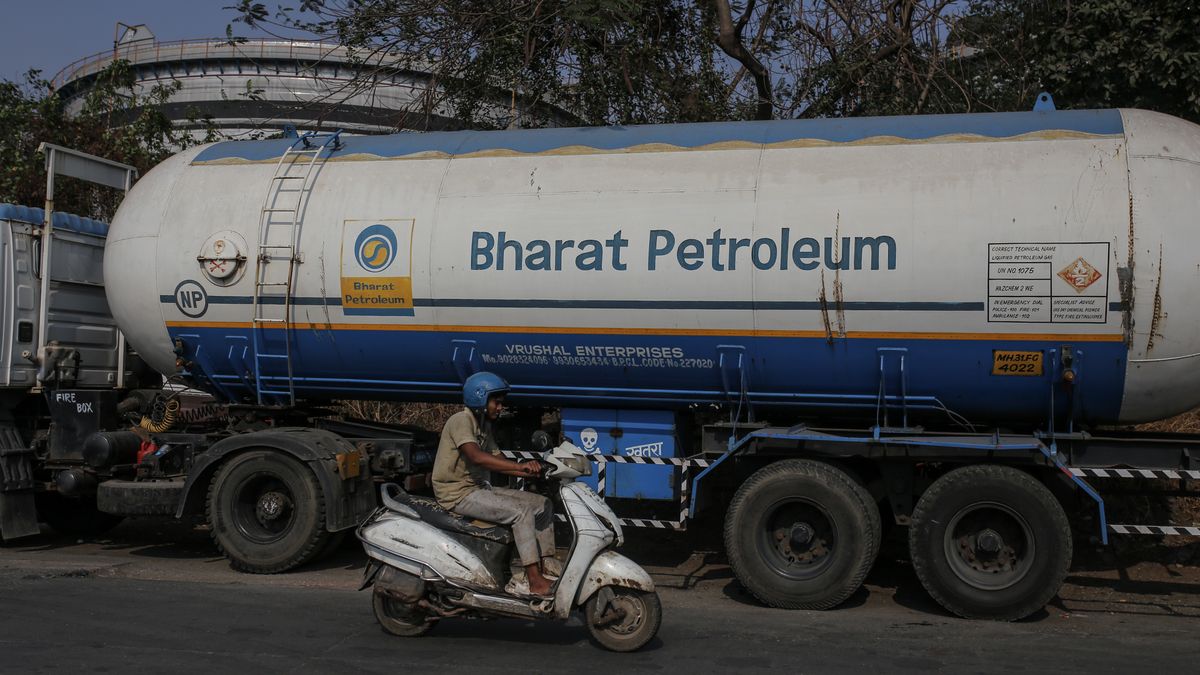 A motorist rides past a Bharat Petroleum Corp. oil tanker truck outside an oil refinery operated by Hindustan Petroleum Corp., in Mumbai, India, on Friday, April 4, 2025. Indian refiners have rushed back to the market to seek crude supply after President Donald Trump's threat of more penalties against Russia raised concerns over potential disruptions to oil flows. Photographer: Dhiraj Singh/Bloomberg via Getty Images