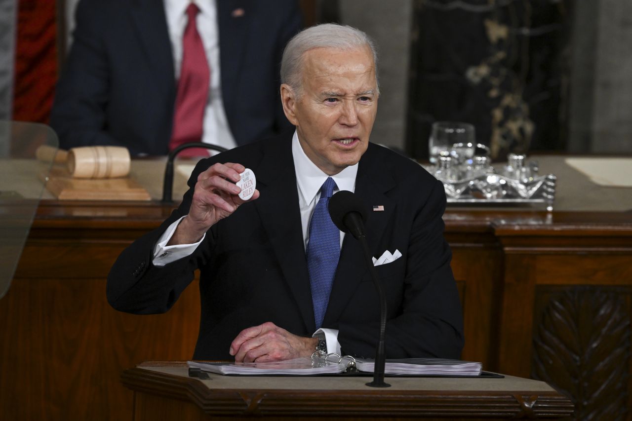 WASHINGTON, DC - MARCH 07: President Joe Biden holds up a button with the name of Laken Riley as he delivers his State of the Union address to a joint session of Congress on Capitol Hill on Thursday, March 7, 2024 in Washington, DC. (Photo by Matt McClain/The Washington Post via Getty Images)