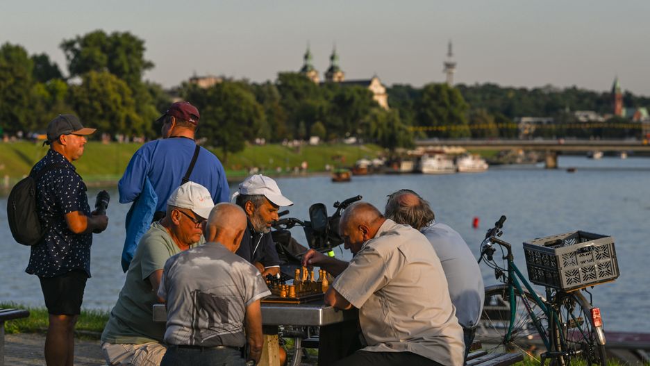 KRAKOW, POLAND - AUGUST 10, 2024:
Locals enjoying a game of chess on the Wisla Riverbank providing a stunning backdrop, on August 10, 2024, in Krakow, Lesser Poland Voivodeship, Poland. (Photo by Artur Widak/NurPhoto via Getty Images)