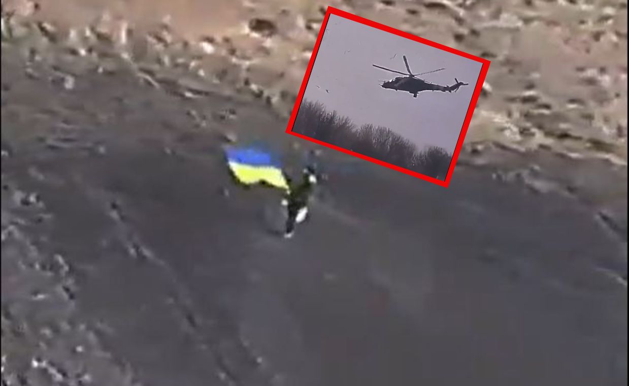 The boy greeted the Ukrainian pilots by waving a flag at them.