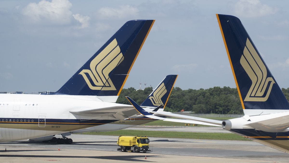 Singapore Airlines Ltd. aircraft at Changi Airport in Singapore, on Wednesday, March 30, 2022. Starting April 1, Singapore will scrap its so-called vaccinated travel lanes and admit all vaccinated travelers who test negative before entering Singapore by air or sea and they will be exempted from quarantine or testing on arrival. Photographer: Ore Huiying/Bloomberg via Getty Images