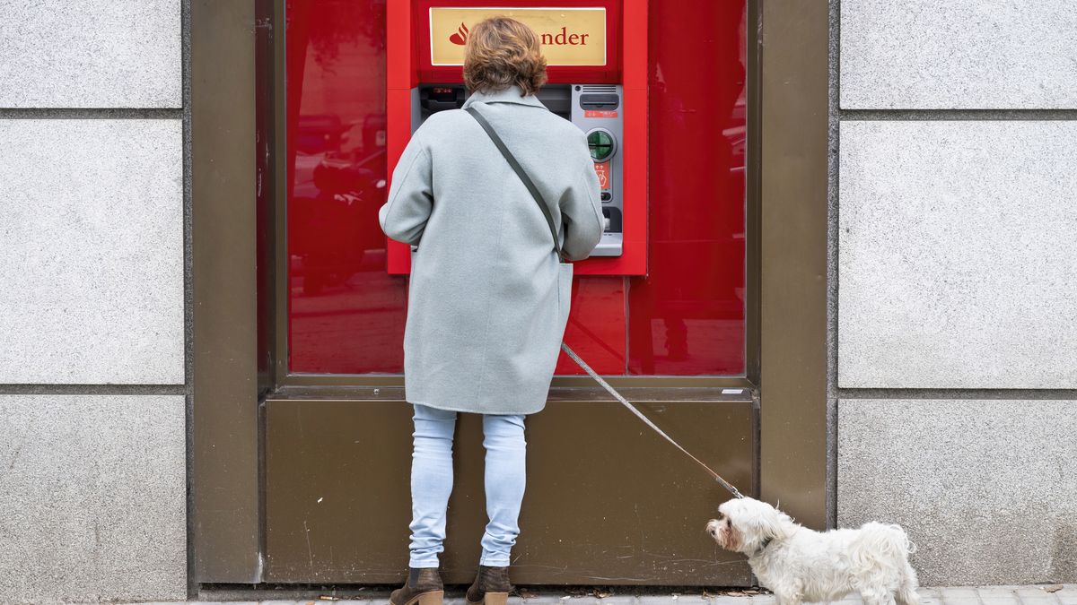 MADRID, SPAIN - 2023/12/13: A customer uses the ATM machine from the Spanish multinational commercial bank and financial services of Santander branch in Spain. (Photo by Xavi Lopez/SOPA Images/LightRocket via Getty Images)
