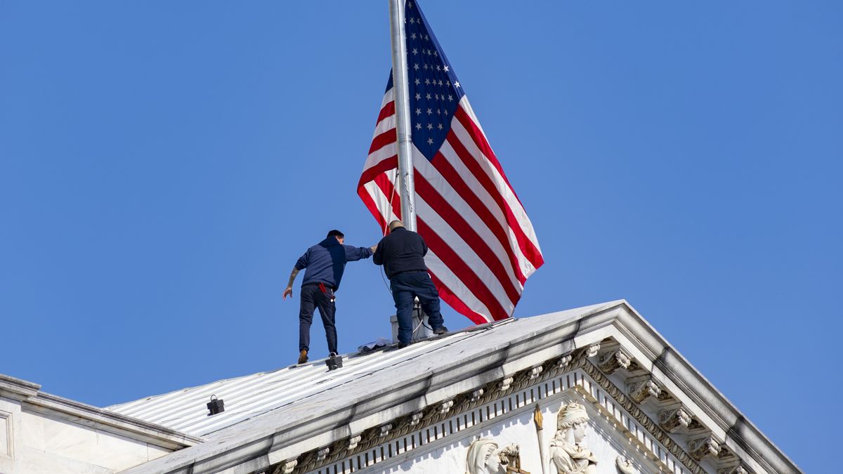 Workers adjusting the flag on the Capitol building. The United States Capitol under a clear blue sky, with American flag waving. Located on Capitol Hill at the eastern end of the National Mall in Washington, D.C., this iconic building is the seat of the U.S. Congress, the legislative branch of the federal government. The Capitol features a dome above its rotunda, designed by Thomas U. Walter and constructed between 1855 and 1866. The Statue of Freedom, a bronze statue, has crowned the dome since 1863. Washington, D.C., USA on May 8. 2023 (Photo by Nicolas Economou/NurPhoto via Getty Images)