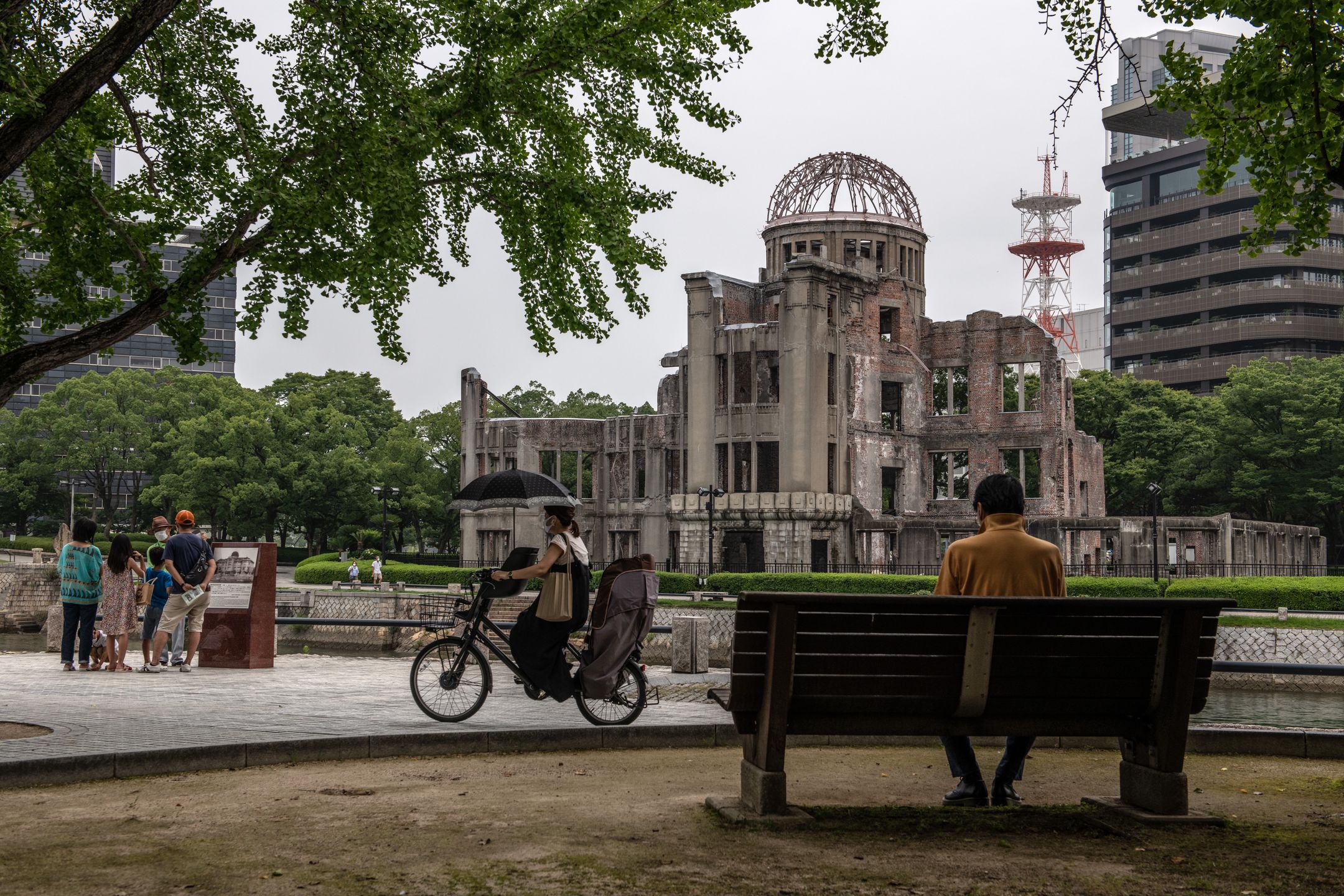 HIROSHIMA, JAPAN - AUGUST 04: A woman cycles past the Atomic Bomb Dome on August 4, 2020 in Hiroshima, Japan. This Thursday will mark the 75th anniversary of the atomic bombing of Hiroshima in which between 90,000 to 146,000 people were killed and the entire city destroyed in the first use of a nuclear weapon in armed conflict. Survivors and dignitaries including Japans Prime Minister Shinzo Abe will attend a commemoration that has been scaled back because of Covid-19 coronavirus. (Photo by Carl Court/Getty Images)