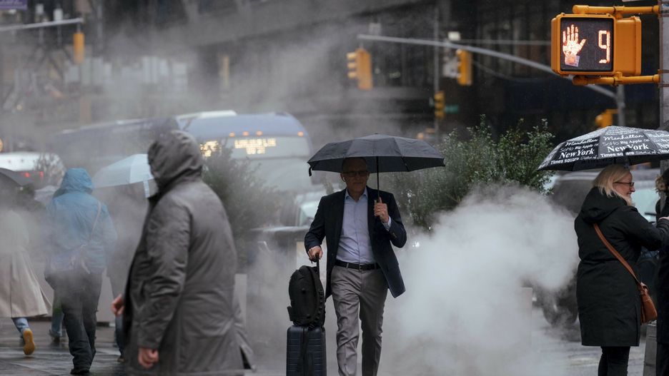 Temporary
People use umbrellas as the rain falls near Times Square, Thursday, Nov. 21, 2024 in New York. (AP Photo/Adam Gray)
Adam Gray