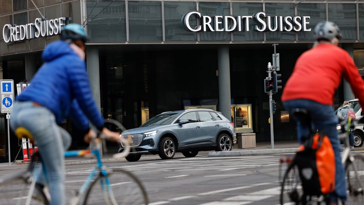 Commuters cycle past a Credit Suisse Group AG bank branch in Basel, Switzerland, on Tuesday, Oct. 25, 2022. Credit Suisse will present its third quarter earnings and strategy review on Oct. 27. Photographer: Stefan Wermuth/Bloomberg via Getty Images