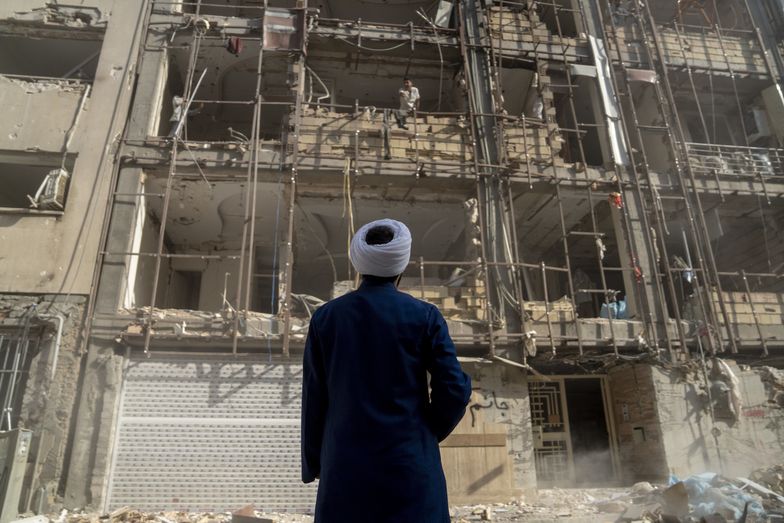 TEHRAN, IRAN - JULY 12: A religion volunteer looks at homes destroyed in recent Israeli attacks. July 12, 2025, in Tehran, Iran. (Photo by Majid Saeedi/Getty Images)