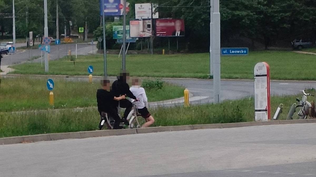 Trzech nastolatków jadących na jednym rowerze miejskim