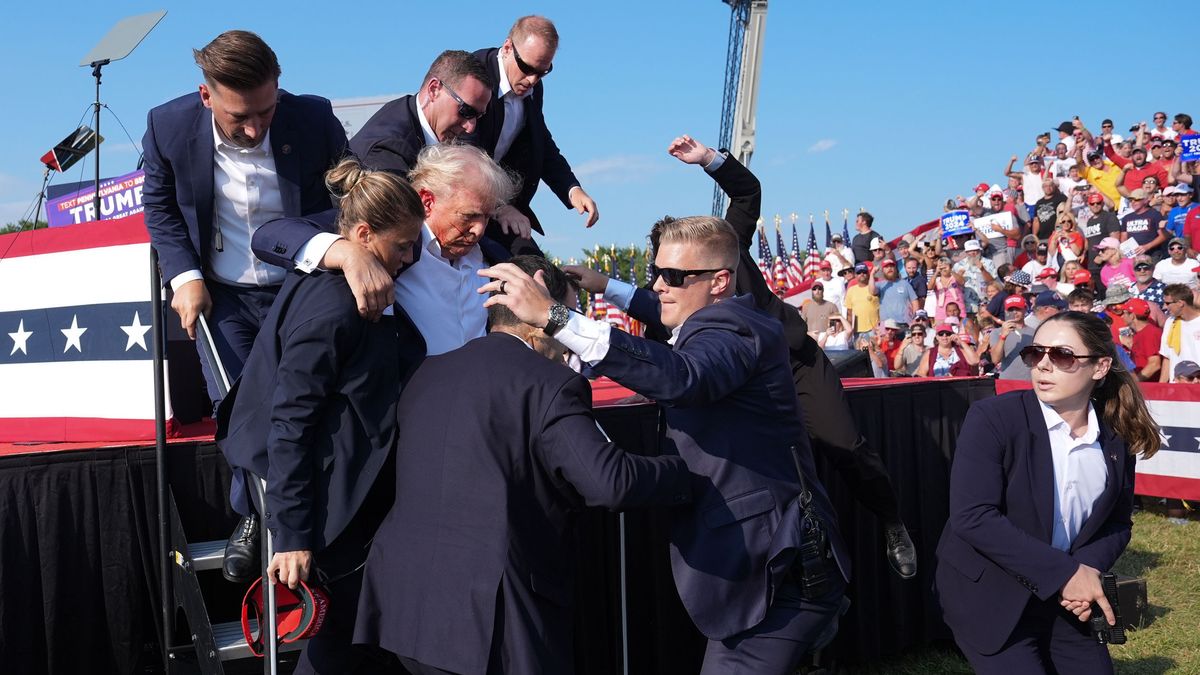 BUTLER, PENNSYLVANIA - July 13: Former president Donald Trump is assisted offstage during a campaign rally for former President Donald Trump at Butler Farm Show Inc. on Saturday, July 13, 2024 in Butler, Pa. Trump ducked and was taken offstage after loud noises were heard after he began speaking. 
(Photo by Jabin Botsford/The Washington Post via Getty Images)