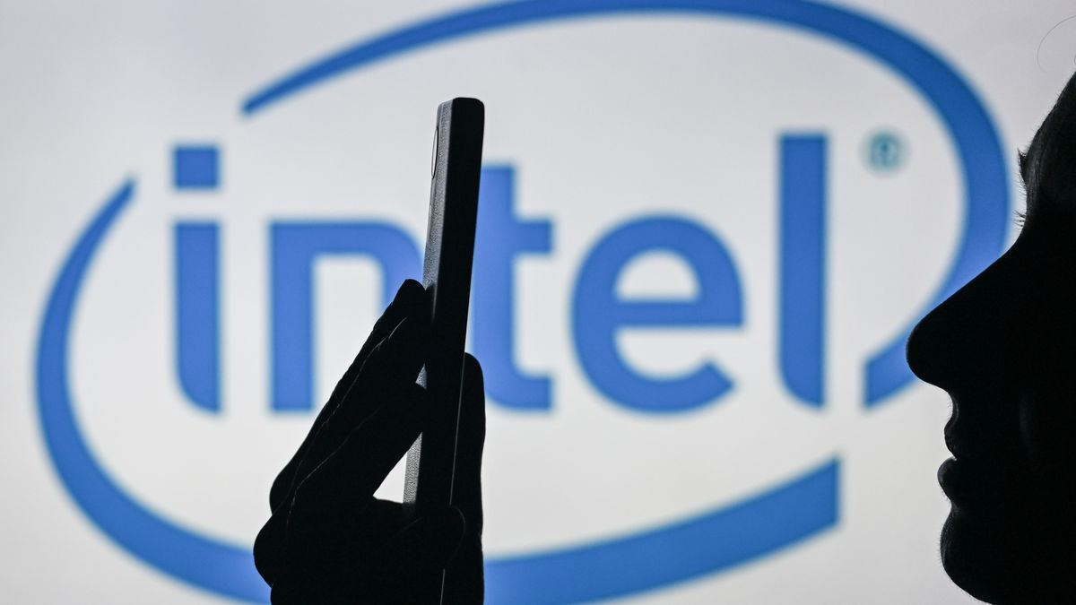 EDMONTON, CANADA - APRIL 28:
An image of a woman holding a cell phone in front of the Intel logo displayed on a computer screen, on April 29, 2024, in Edmonton, Canada. (Photo by Artur Widak/NurPhoto via Getty Images)