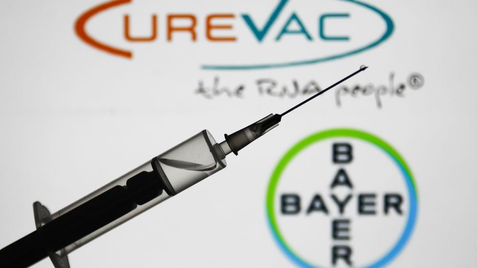 Medical syringe is seen with Bayer and CureVac logos displayed in the background in this illustration photo taken in Poland on January 7, 2021. Bayer and CureVac will team up in works to develop their COVID-19 vaccine. (Photo by Jakub Porzycki/NurPhoto via Getty Images)
