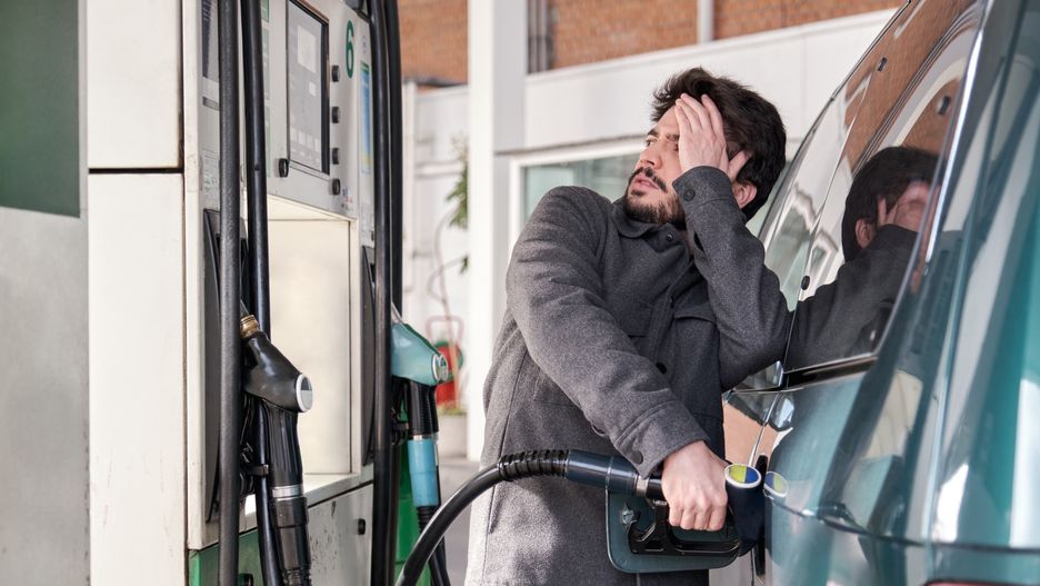 Young man refueling his vehicle while looking worried at the high gas prices.
Young man refueling his vehicle while looking worried at the high gas prices at a gas station.
Ladanifer