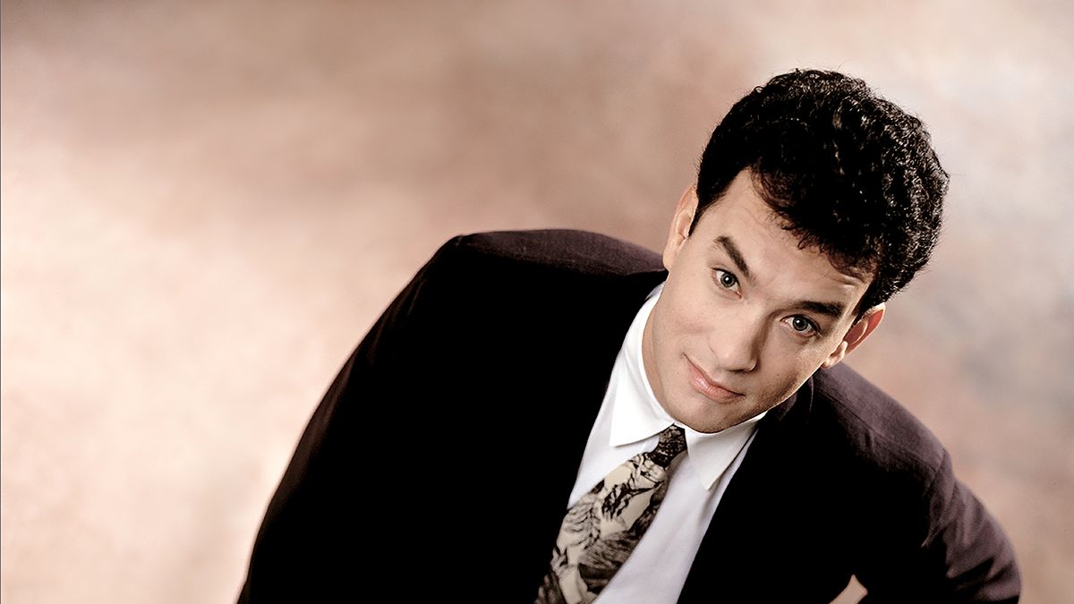 Actor Tom Hanks looks up at the camera in a suit in Los Angeles in 1980. (Photo by Bonnie Schiffman/Getty Images)