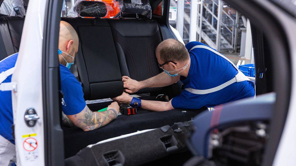 Employees fix the seats of a Volkswagen AG (VW) ID.5 electric sports utility vehicle (eSUV) on the assembly line at the automaker's electric automobile plant in Zwickau, Germany, on Tuesday, April 26, 2022. The Zwickau assembly lines are the centerpiece of a plan by VW, the world's biggest automaker, to manufacture as many as 330,000 cars annually. Photographer: Krisztian Bocsi/Bloomberg via Getty Images