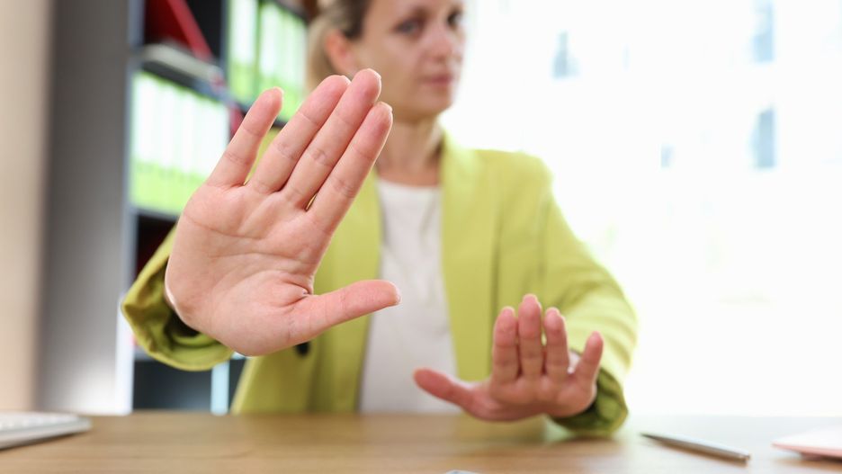 Business woman refusing to take bribe. Female at desk and money on table.