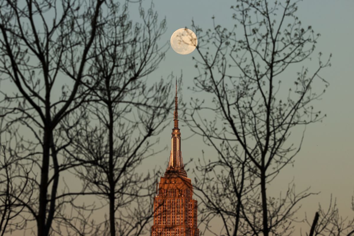 NEW YORK, NY - APRIL 15: The Full Pink moon rises behind the Empire State Building in Manhattan of New York City, United States on April 15, 2022. (Photo by Tayfun Coskun/Anadolu Agency via Getty Images)