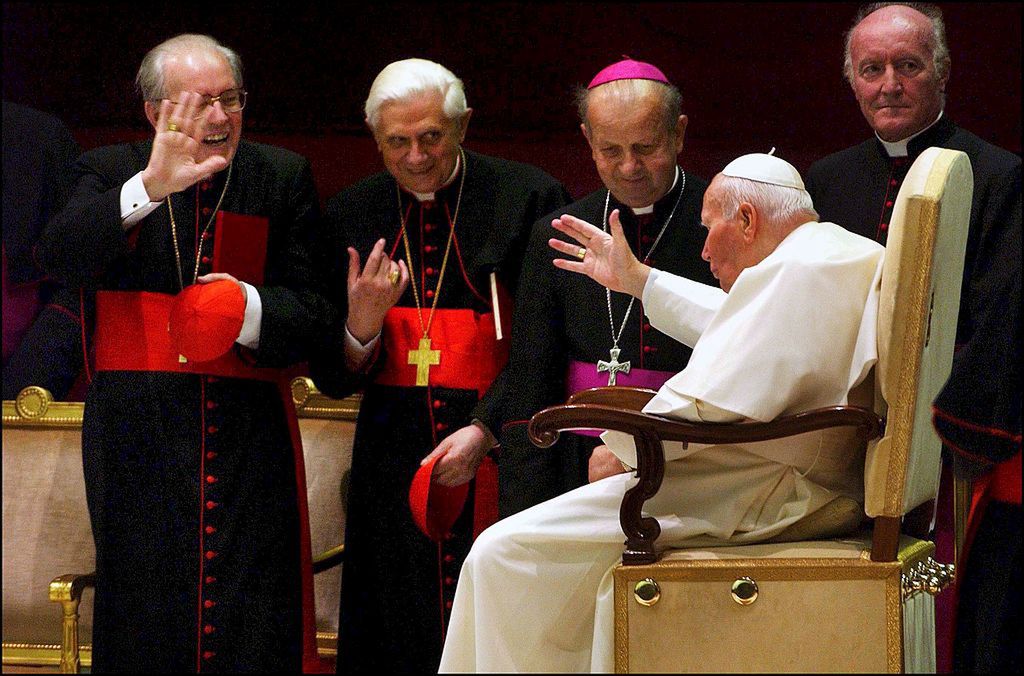 Pope John Paul II signed the Post-Synodal Apostolic Exhortation on the ministry of bishops during a meeting with cardinals and bishops at the Vatican the day of the 25th anniversary of his election in Rome, Italy on October 16th, 2003.VATICAN - OCTOBER 16:  Cardinals Giovanni Battista Re (L) and Joseph Ratzinger and pape's secretary Stanislau Dziwisz in Rome, Italy on October 16th, 2003.  (Photo by Eric VANDEVILLE/Gamma-Rapho via Getty Images)Eric VANDEVILLEAnniversary, Bishop, Cardinal, Christianity, Color, Color photo, German, Holy Father, Holy See, Italian, Jubilee, Minister of religion, Papacy, Pole, Pope, Religious personality, Sacred College, Supreme Pontiff, Synod, archbishopric, catholic religion Roman Catholic Church, pontiff, pontificate