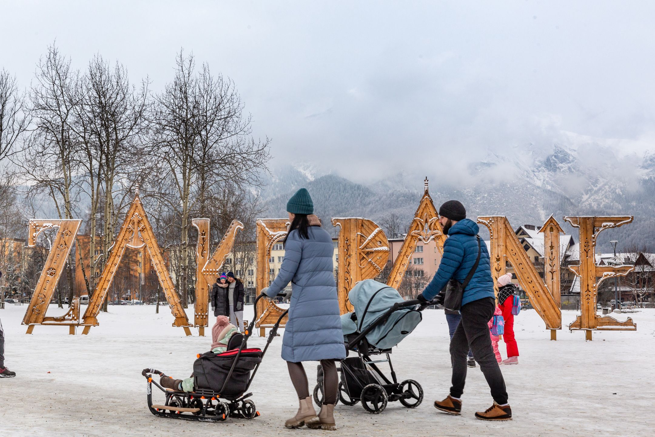 ZAKOPANE, MALOPOLSKIE, POLAND - 2024/01/19: Families walk in a public park in front of Zakopane sign in the center of Zakopane a popular Tatra mountain holiday resort. (Photo by Dominika Zarzycka/SOPA Images/LightRocket via Getty Images)
