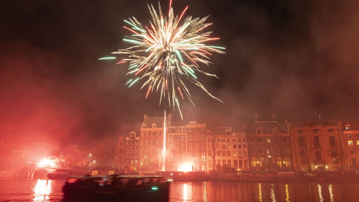 AJAX supporters celebrate the 125th anniversary of the football club. Thousands of fans of the historic Dutch FC travel and gather in Amsterdam, the Netherlands, on March 18, 2025, to march through the city and set up fireworks and flares while chanting their favorite slogans. The fans walk until the Amstel River where they set up a show with multiple fireworks lighting up the night sky of the capital. (Photo by Gene Medi/NurPhoto via Getty Images)