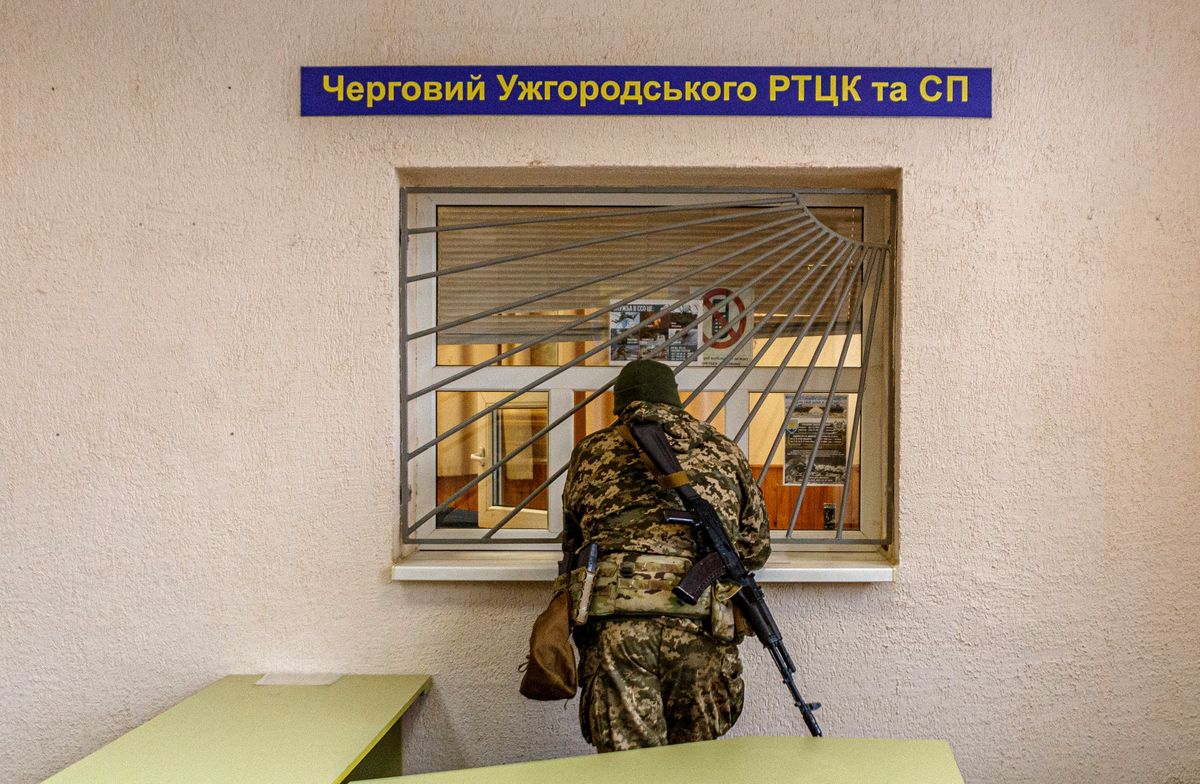 An armed man in a camouflage uniform is pictured at the Zakarpattia Regional Territorial Centre for Staffing and Social Support, Uzhhorod, Zakarpattia Region, western Ukraine, on February 25, 2022, in Uzhhorod, Ukraine.  (Photo by SerhiiHudak/Ukrinform/NurPhoto via Getty Images)