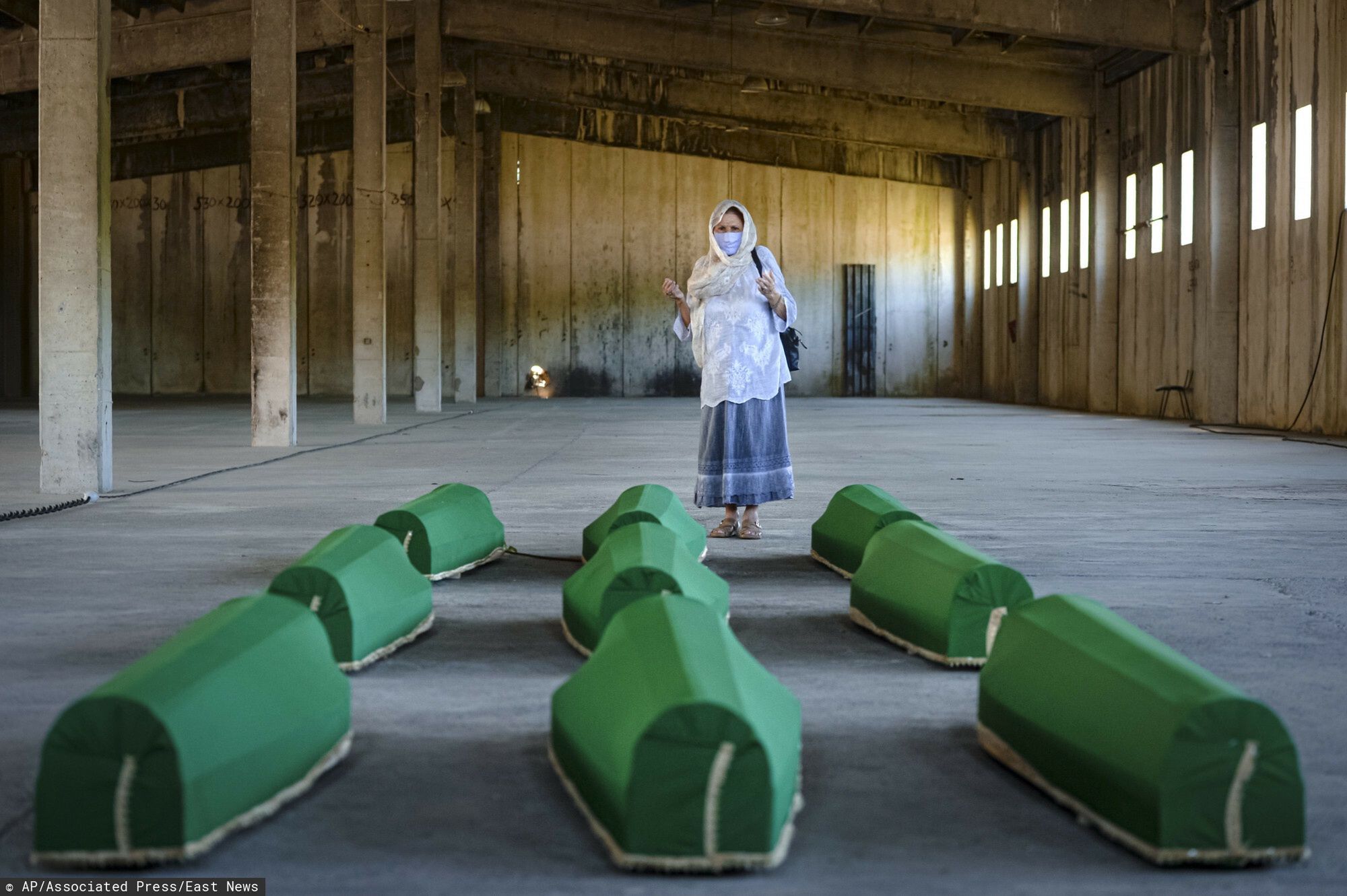 arch40A woman prays next to victims' coffins inside the former UN base in Potocari, near Srebrenica, Bosnia, Friday, July 10, 2020. Nine newly found and identified men and boys will be laid to rest when Bosnians commemorate on Saturday 25 years since more than 8,000 Bosnian Muslims perished in 10 days of slaughter, after Srebrenica was overrun by Bosnian Serb forces during the closing months of the country's 1992-95 fratricidal war, in Europe's worst post-WWII massacre. (AP Photo/Kemal Softic)AP