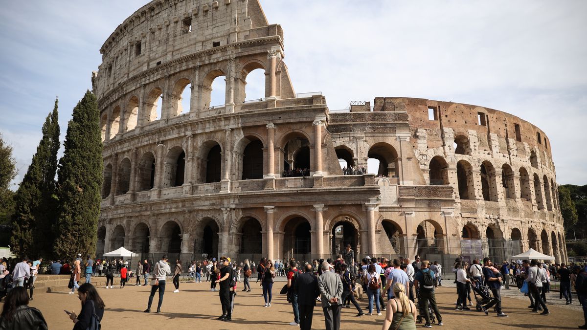 Tourists walking ahead of Coloseum in Rome, Italy (Photo by AB/NurPhoto via Getty Images)