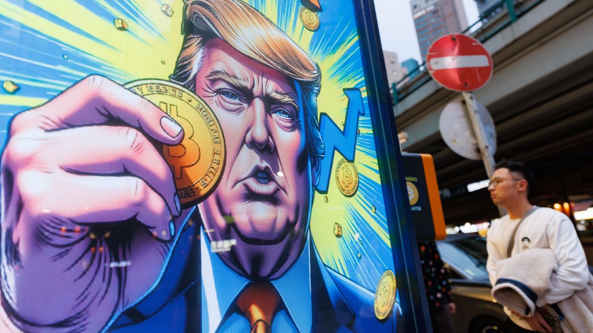 HONG KONG, CHINA - 2025/04/06: People walk past an advertisement feature Donald Trump with Bitcoin in Hong Kong. U.S. reciprocal tariffs sent shockwaves to global financial markets, with cryptocurrencies also experiencing declines. Bitcoin, the world's largest cryptocurrency by market value, fell more than 5% to $78,892.92 at 1855 GMT on Sunday. (Photo by May James/SOPA Images/LightRocket via Getty Images)