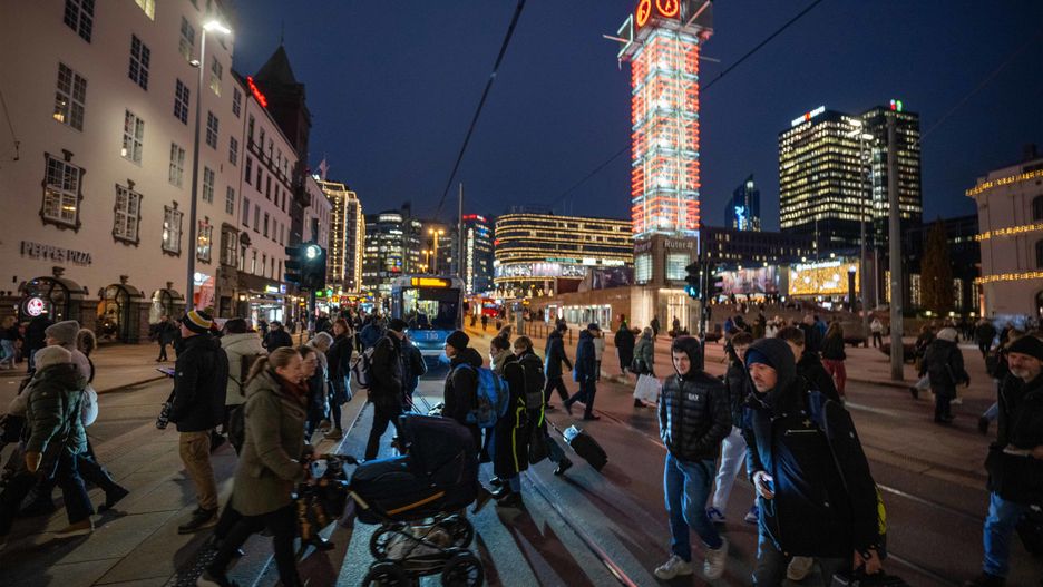 People are walking along a crosswalk near a bus in the central business district of Oslo, Norway, on November 17, 2023. (Photo by Jorge Mantilla/NurPhoto via Getty Images)