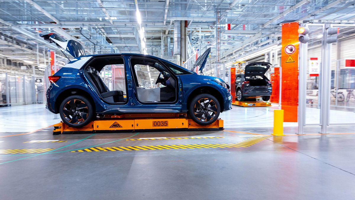 An automated guided vehicle (AGV) moves a Seat Cupra Born electric vehicle (EV) on the assembly line at the Volkswagen AG (VW) electric automobile plant in Zwickau, Germany, on Tuesday, April 26, 2022. The Zwickau assembly lines are the centerpiece of a plan by VW, the world's biggest automaker, to manufacture as many as 330,000 cars annually. Photographer: Krisztian Bocsi/Bloomberg via Getty Images