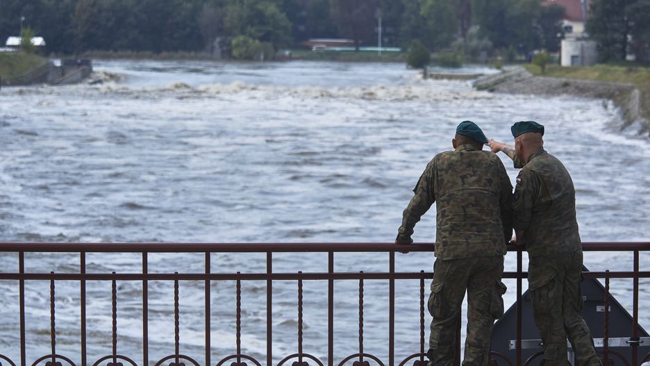 Polish soldiers look at the high water level on the Oder River in central Wroclaw, Poland, on Thursday, Sept. 19, 2024. The Polish and Czech economies will take a knock and government coffers are going to get more stretched all while ministers try to move quickly to demonstrate they are on top of the crisis. Photographer: Bartek Sadowski/Bloomberg via Getty Images