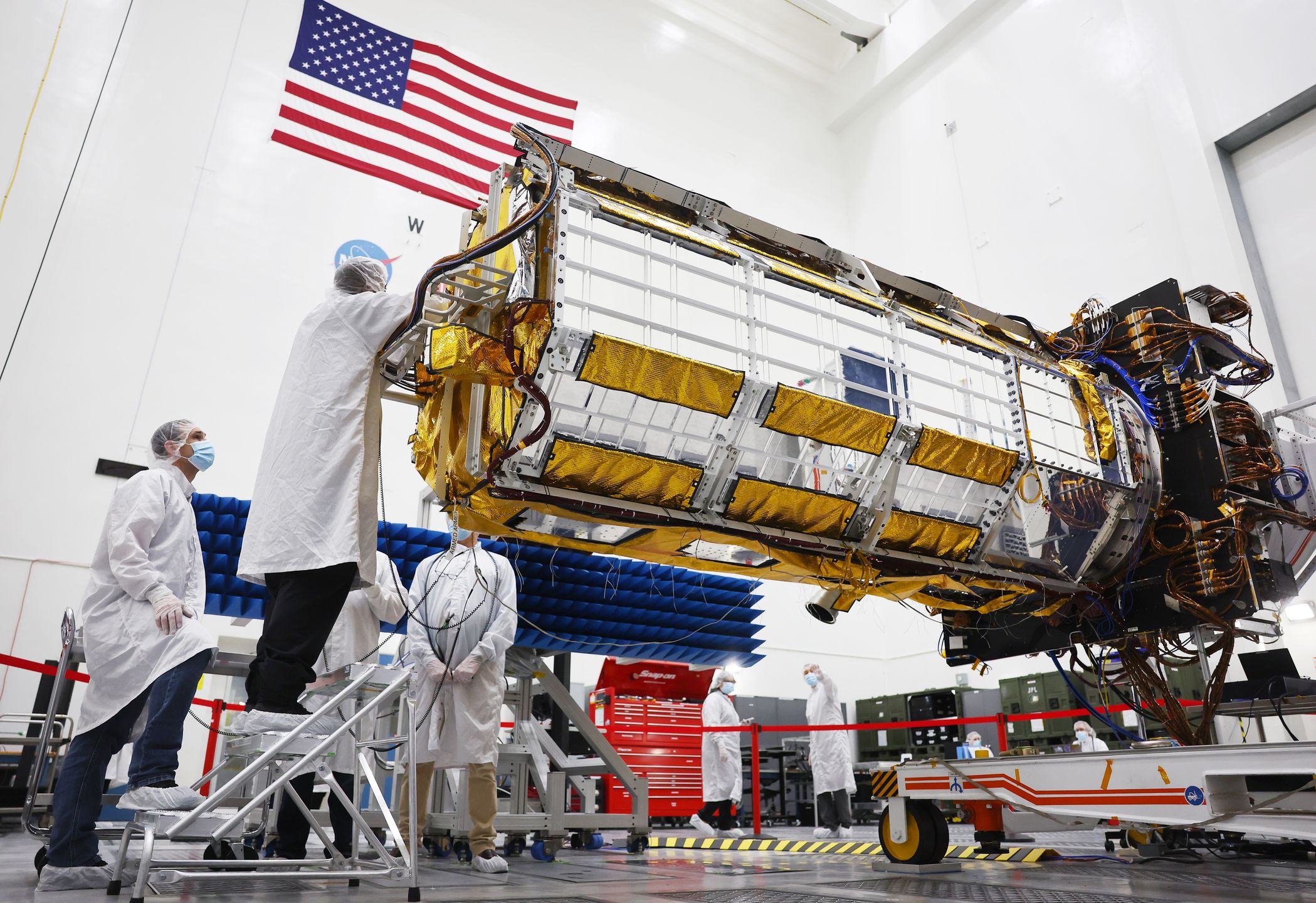 PASADENA, CALIFORNIA - FEBRUARY 03: Clean room engineers and technicians prepare the scientific core of the NASA-ISRO Synthetic Aperture Radar (NISAR) satellite inside a Spacecraft Assembly Facility clean room at NASA's Jet Propulsion Laboratory (JPL) on February 3, 2023 in Pasadena, California. The joint satellite mission between NASA and the Indian Space Research Organization (ISRO) will ‘measure Earth’s changing ecosystems’ along with ice sheets and glaciers, volcanoes, earthquakes, and groundwater reserves. According to NASA, ‘NISAR measurements will have a major impact on projections of climate change.’ (Photo by Mario Tama/Getty Images)