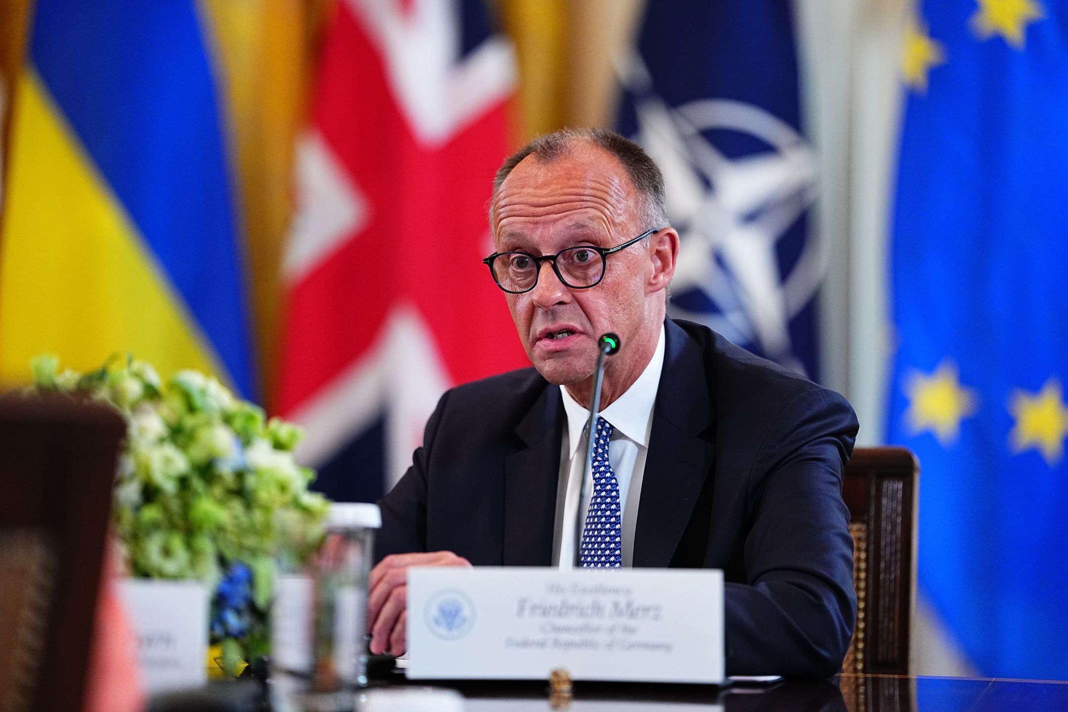 Friedrich Merz, Germany's chancellor, speaks during a multilateral meeting with European leaders in the East Room of the White House in Washington, DC, US, on Monday, Aug. 18, 2025. US President Donald Trump said he hoped to secure an agreement for a trilateral meeting with Vladimir Putin and Ukrainian President Volodymyr Zelenskiy as he welcomed the Ukrainian leader to the White House for high-stakes talks on bringing an end to Russia's war on Ukraine. Photographer: Aaron Schwartz/CNP/Bloomberg via Getty Images