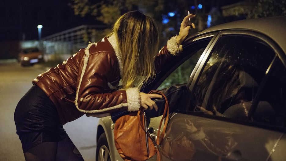 Woman soliciting someone in a car on the streetProstitution in a city - night prostitute talking to potential customermicrogenBeautiful, One Young Woman Only, Young Women, Women, Female, Criminal Activity, City Life, Women's Issues, Sexual Issues, Roadside, Red Light District, Stockings, Bending, Color Image, Prostitute, Adult, Leaning, Standing, Sexual Activity, Touching, Street Light, Customer, Caucasian, Despair, Sensuality, Forbidden, Dark, Yellow, Red, Social Issues, Urban Scene, Horizontal, Side View, Blond Hair, The Human Body, People, Night, City Street, Street, Road, Suburb, City, Car, Attractive Female, Human Trafficking, Sex Worker, Prostitution