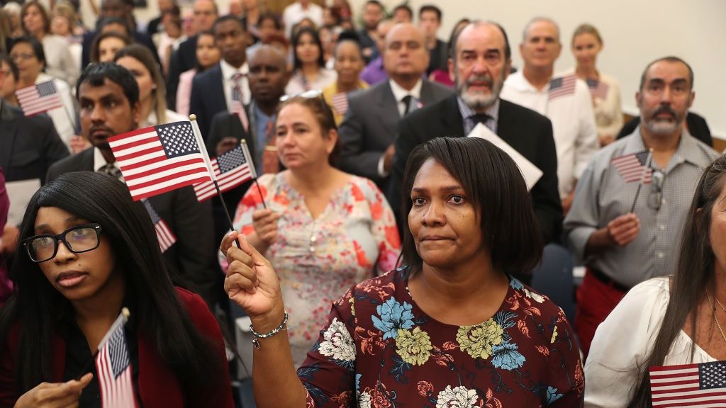 Immigrants Become U.S. Citizens During Naturalization Ceremony In Miami
MIAMI, FLORIDA - AUGUST 16: Michele Gray (C), originally from Jamaica, joins with other people during a ceremony to become American citizens at a U.S. Citizenship & Immigration Services naturalization ceremony in a Miami Field Office on August 16, 2019 in Miami, Florida. The ceremony included 150 citizenship candidates from across the globe.  (Photo by Joe Raedle/Getty Images)
Joe Raedle