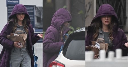 Zakapturzona Joanna Opozda z nietęgą miną ucieka przed deszczem. Widać, że tęskni za słoneczkiem na Bali?