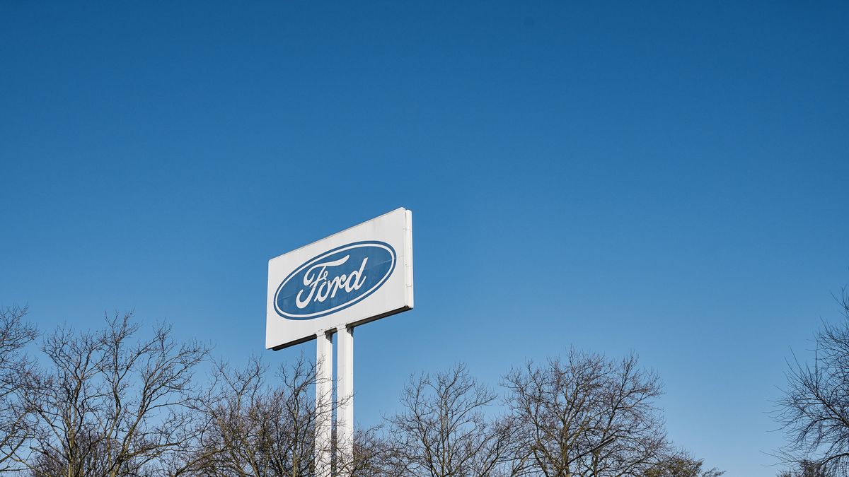 A Ford Motor Co. logo  sits on display outside a Ford factory as coronavirus halts the automaker's German automobile assembly operations in Cologne, Germany, on Tuesday, March 24, 2020. Ford was downgraded by Fitch Ratings as the coronavirus pandemic sends shock waves through supply chains and all but wipes out demand across the auto industry. Photographer: Wolfram Schroll/Bloomberg via Getty Images