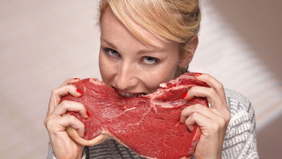 Woman eating steak