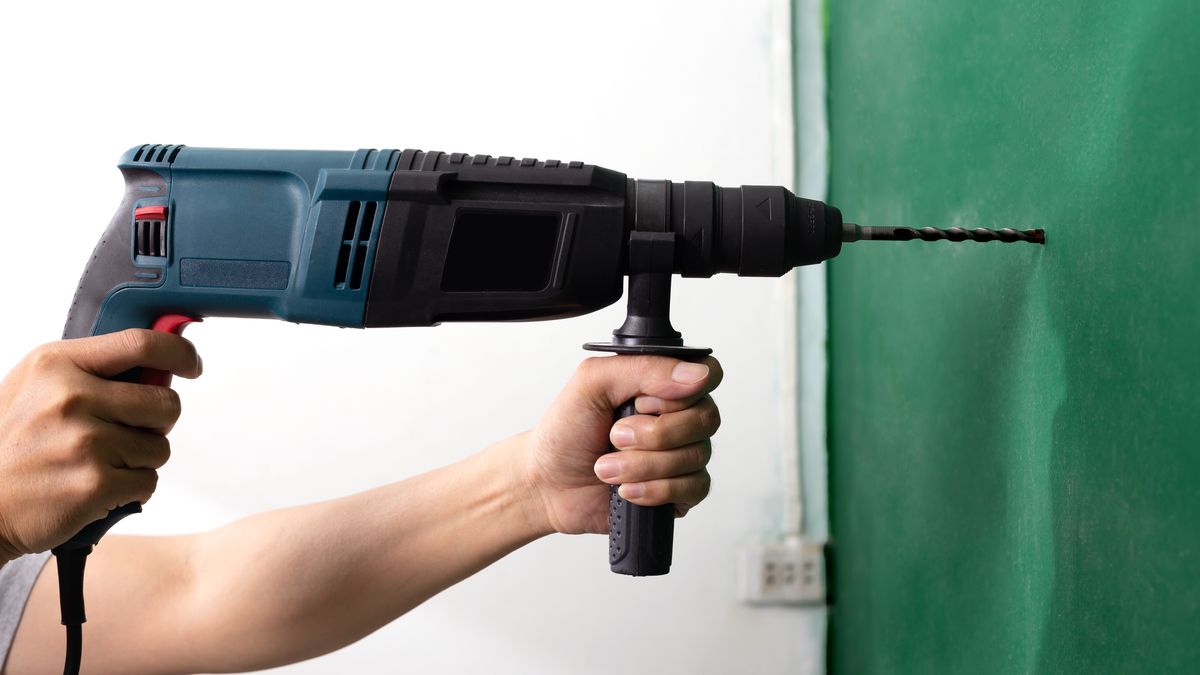 background, builder, concrete, construction, contractor, craftsperson, development, drill, drilling, electric, engineer, equipment, hammer, hand, holding, house, housework, human, industrial, industry, instrument, isolated, job, labor, machine, male, man, manual, metal, noisy, object, occupation, people, perforator, person, photo, power, professional, renovation, repair, repairman, rotary, safety, service, steel, tool, wall, white, work, worker