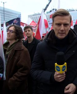 Reporter "Faktów" TVN na marszu. W tle okrzyki