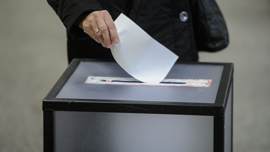 VILNIUS, LITHUANIA - 2024/10/27: A voter drops a ballot into the ballot box during the second round of parliamentary elections at a polling station. Lithuania holds the second round of parliamentary elections. The opposition Social Democratic Party won the first round. (Photo by Yauhen Yerchak/SOPA Images/LightRocket via Getty Images)
