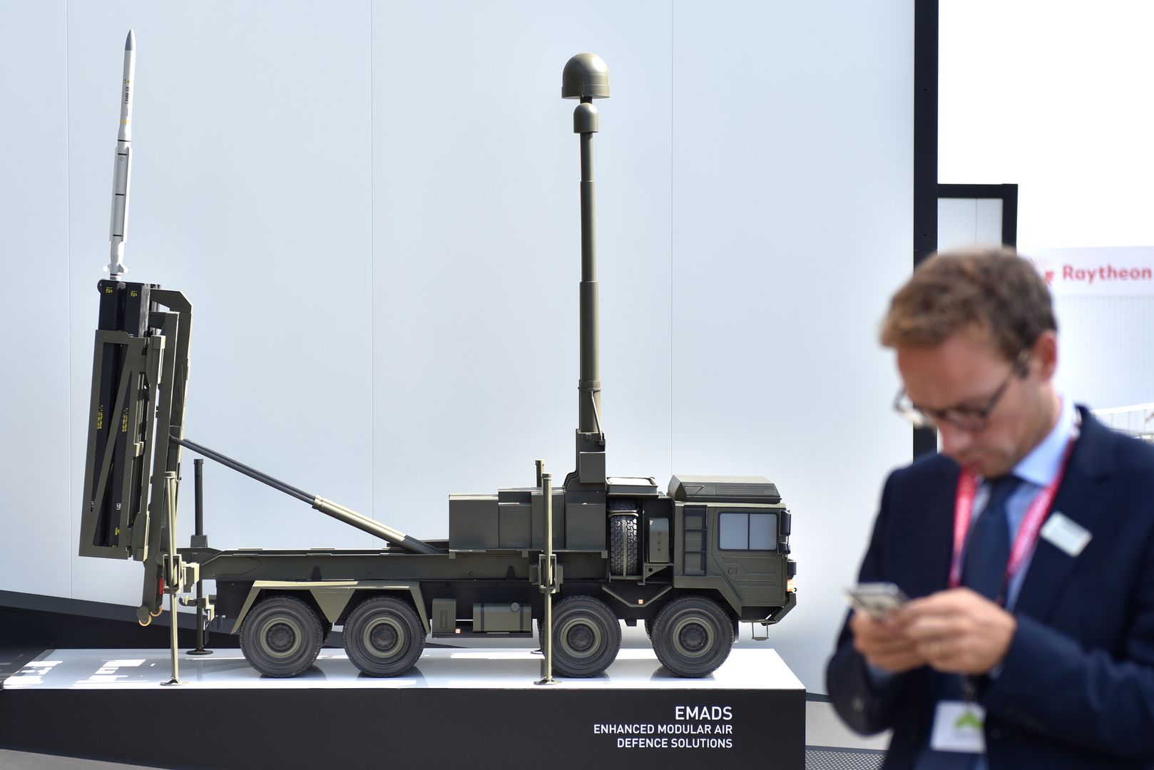 FARNBOROUGH, ENGLAND - JULY 19: A man makes a call on his phone beside a model of an EMADS Enhanced Modular Air Defence Solution vehicle at the MBDA systems stand during the Farnborough International Airshow 2022 on July 19, 2022 in Farnborough, England. Farnborough International Airshow 2022 will host leading innovators from the aerospace, aviation and defence industries. (Photo by John Keeble/Getty Images)